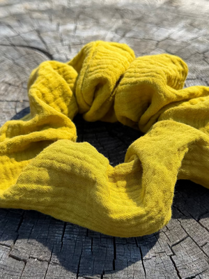 Yellow scrunchie on a wooden surface